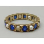 A 9ct gold, blue stone and pearl eternity ring, 2.9g, L