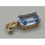 A 9ct gold, emerald cut blue topaz pendant, 18.3mm x 13.2mm x 8mm, approximately 17ct weight