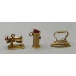 Three 9ct gold charms, sewing machine, iron and lipstick, 2.9g