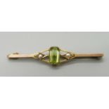 A yellow metal, peridot and pearl brooch (tests as 9ct gold), 2.8g