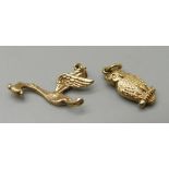 A 9ct gold stork and baby charm and a 9ct gold owl charm, 1.9g