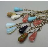 Twelve gemstone pendants on silver chains