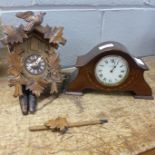 A cuckoo clock and a mantel clock, the dial marked W.H. May, Nottingham