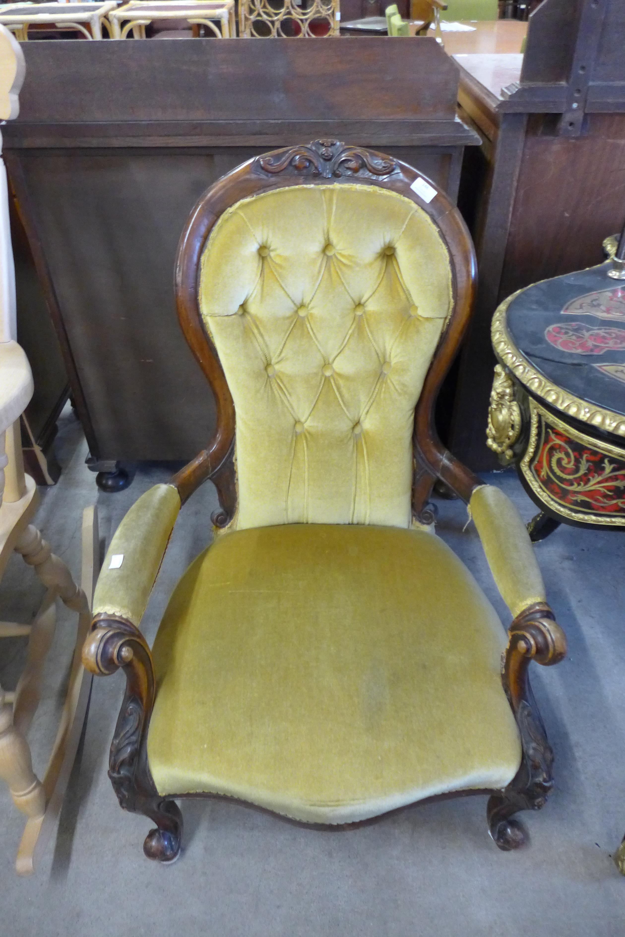 A Victorian carved mahogany and upholstered armchair