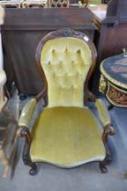 A Victorian carved mahogany and upholstered armchair