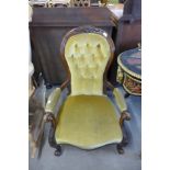 A Victorian carved mahogany and upholstered armchair