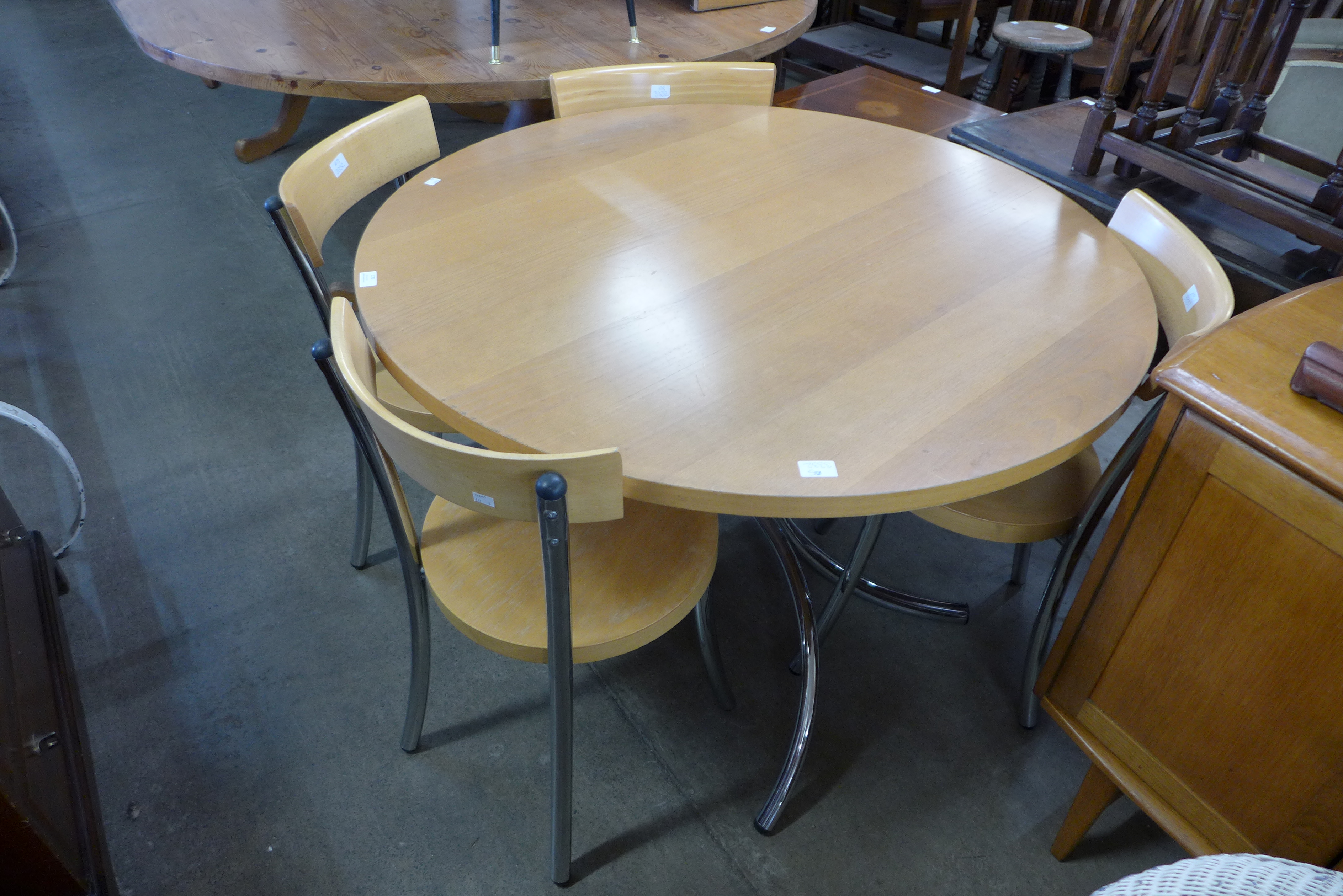 A circular chrome and beech kitchen table and four chairs