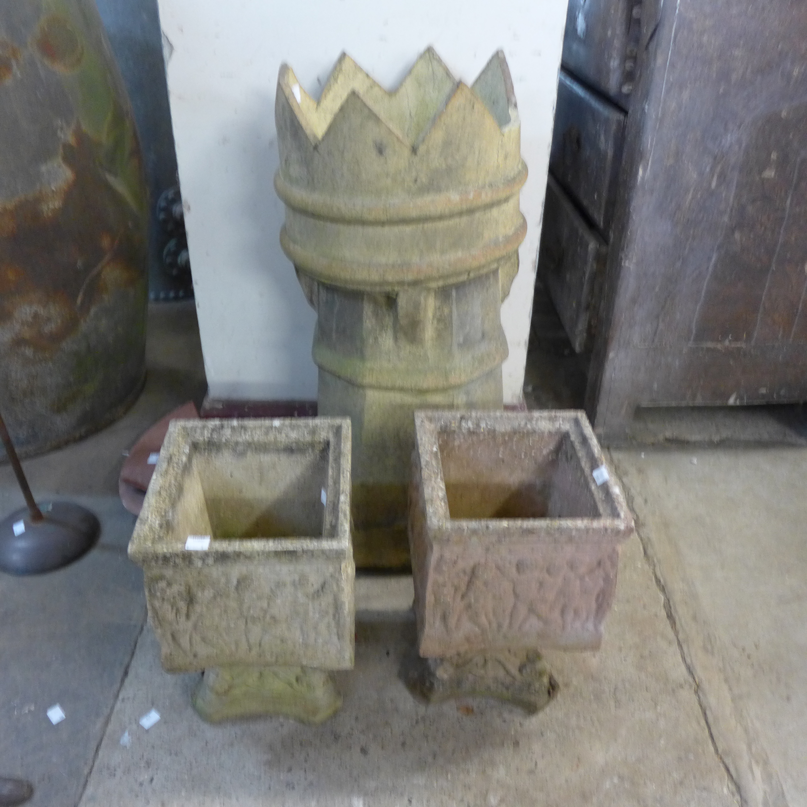 A pair of concrete planters on stands and a Victorian crown chimney pot, a/f