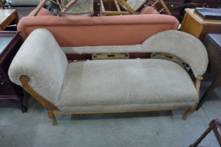 An Edward VII carved walnut and upholstered chaise longue