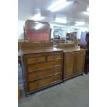 A Jacobean style carved oak dressing chest and a similar two door fitted cupboard