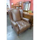 A Laura Ashley brown leather wingback armchair