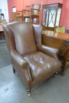 A Laura Ashley brown leather wingback armchair