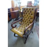 A Chesterfield mahogany and tan leather library chair