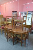 A teak extending dining table and six chairs