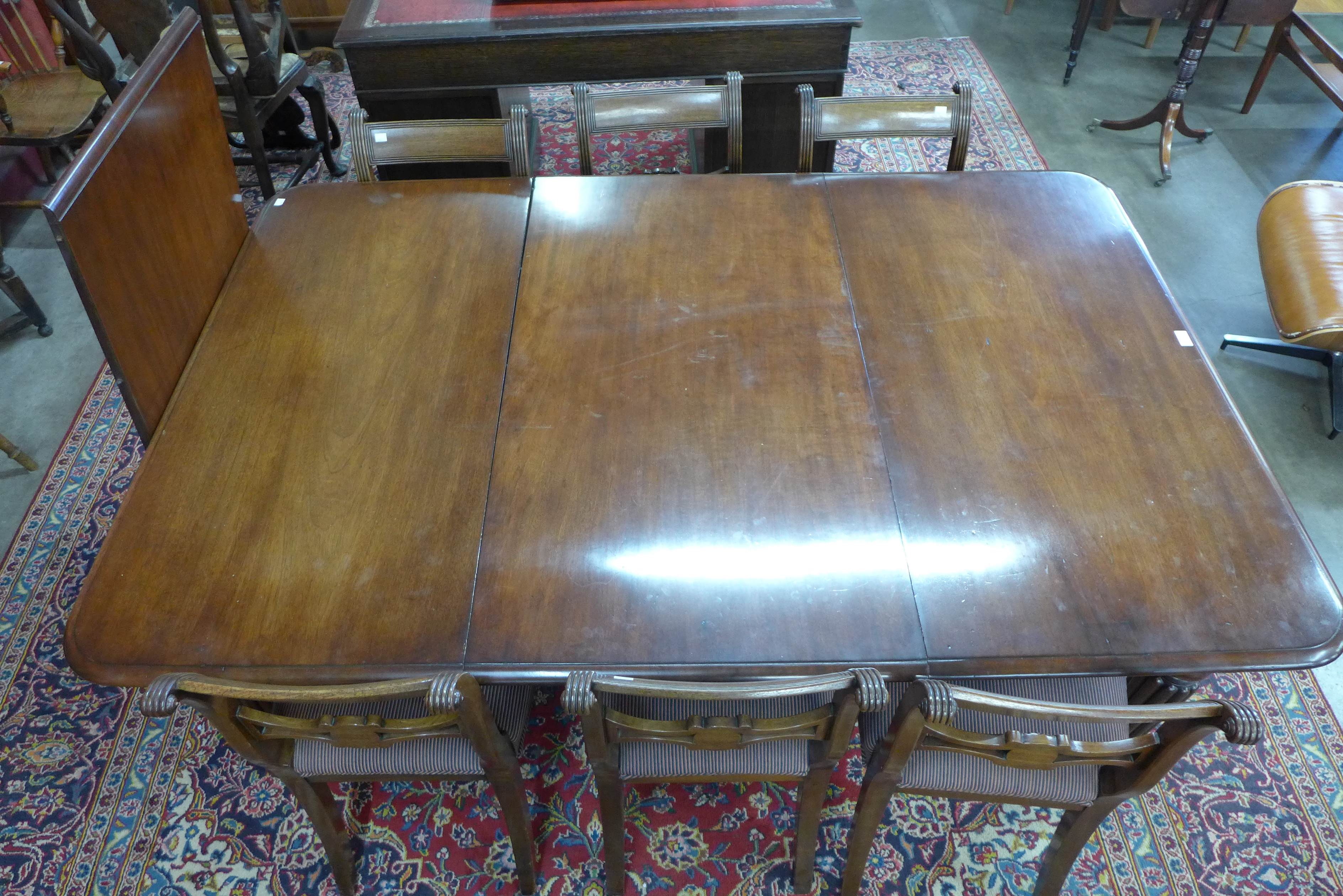 A Victorian mahogany extending dining table and six Regency style chairs, table dimensions; 72cms h, - Image 5 of 5