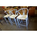 A set of three Hans Wagner style painted beech stools