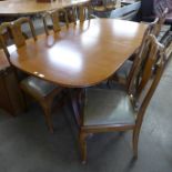 An inlaid mahogany and walnut eight piece dining suite