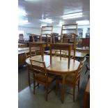 A McIntosh teak extending dining table and six chairs