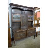 An early 20th century carved oak Greenman dresser