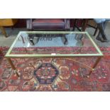 An Italian brass and glass topped coffee table