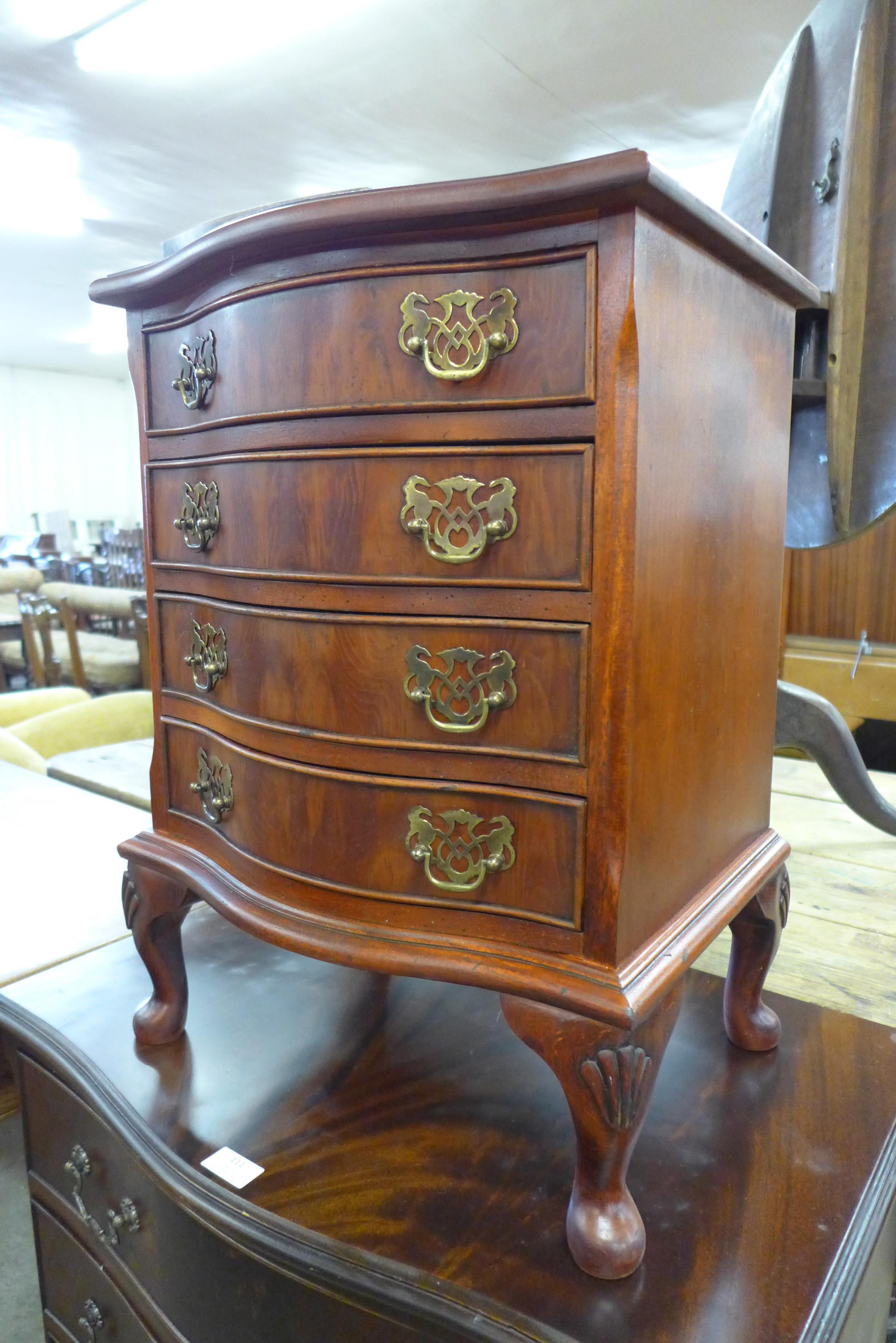 A small mahogany serpentine chest