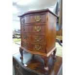 A small mahogany serpentine chest