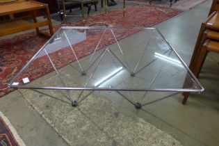 A chrome and glass topped atomic style coffee table