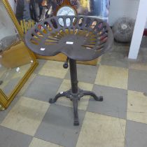 An industrial style steel tractor seat revolving stool