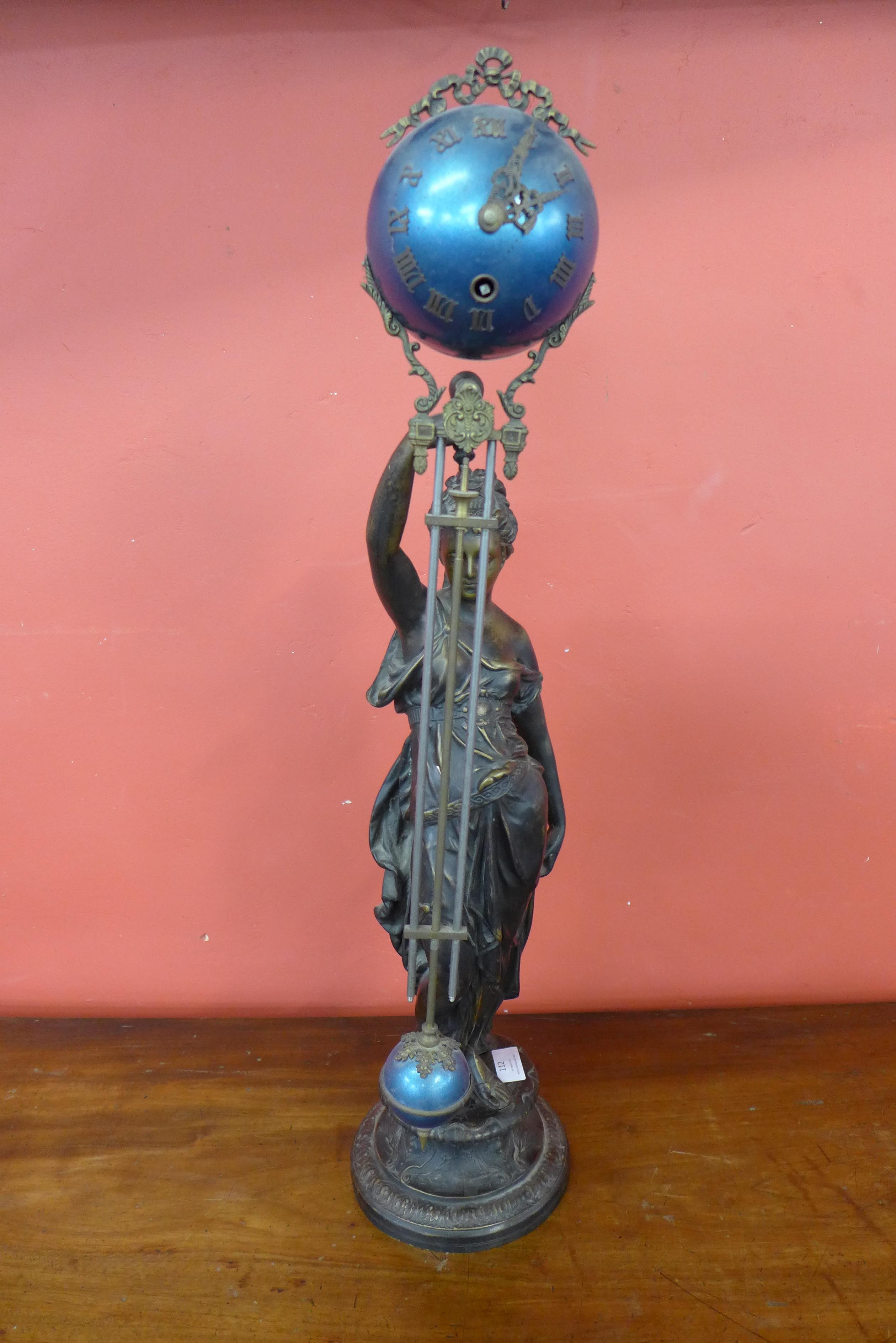 A French bronze and enamelled figural swing arm mantel clock