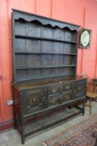 A Jacobean Revival carved oak dresser