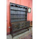 A Jacobean Revival carved oak dresser