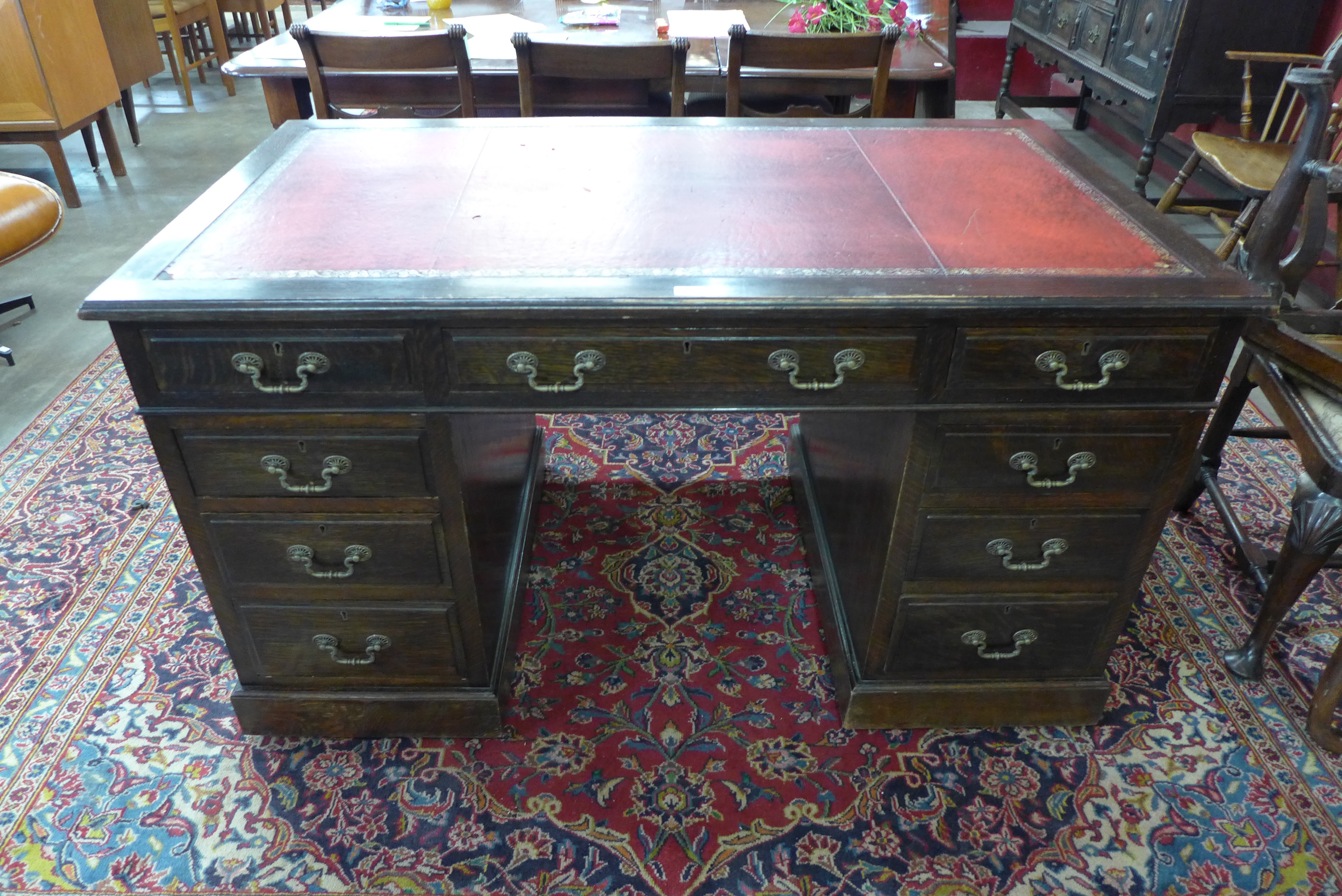 A Victorian oak and red leather topped desk