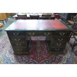 A Victorian oak and red leather topped desk