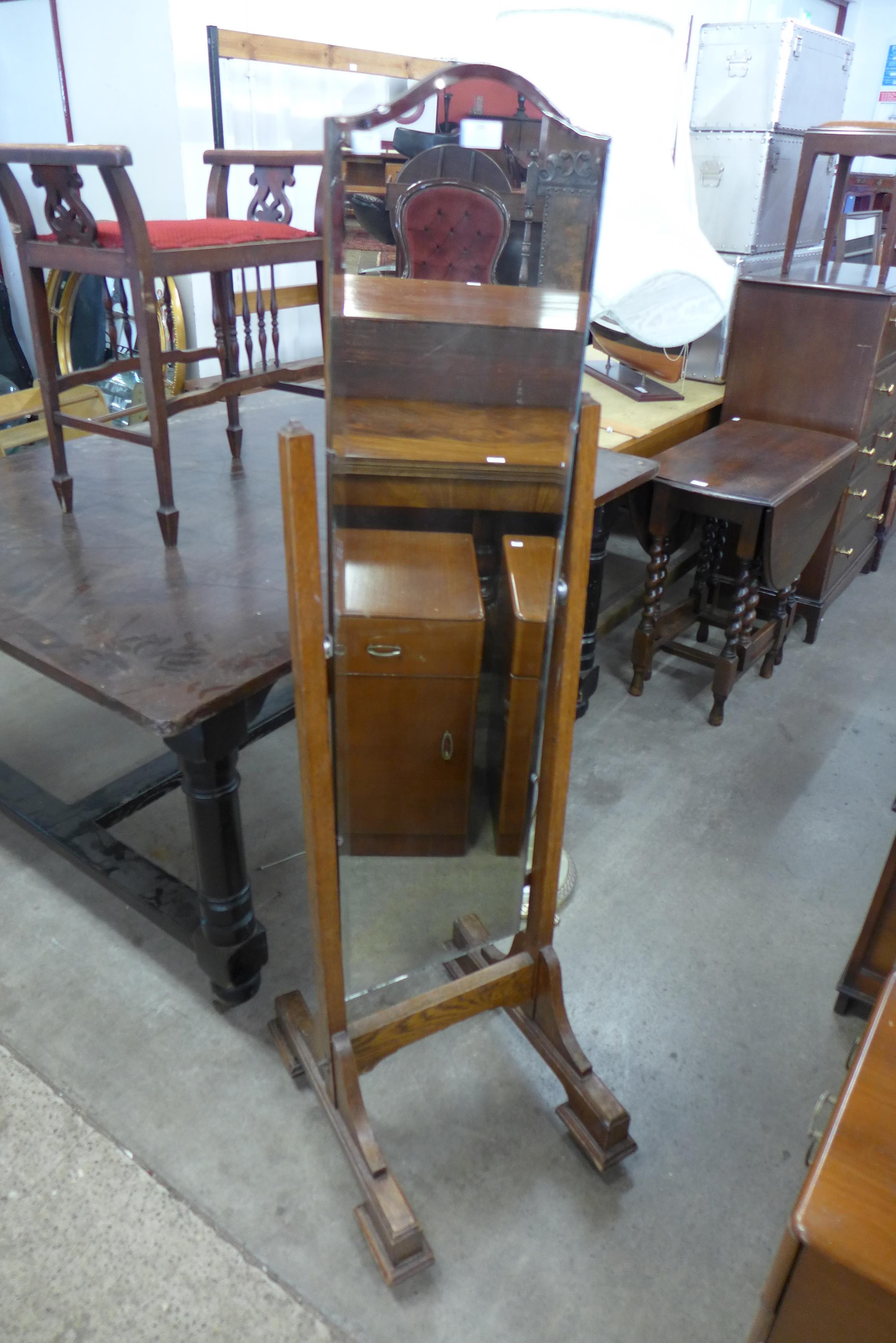 An Art Deco oak cheval mirror