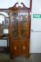 An Edward VII style inlaid mahogany free standing corner cabinet