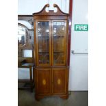 An Edward VII style inlaid mahogany free standing corner cabinet