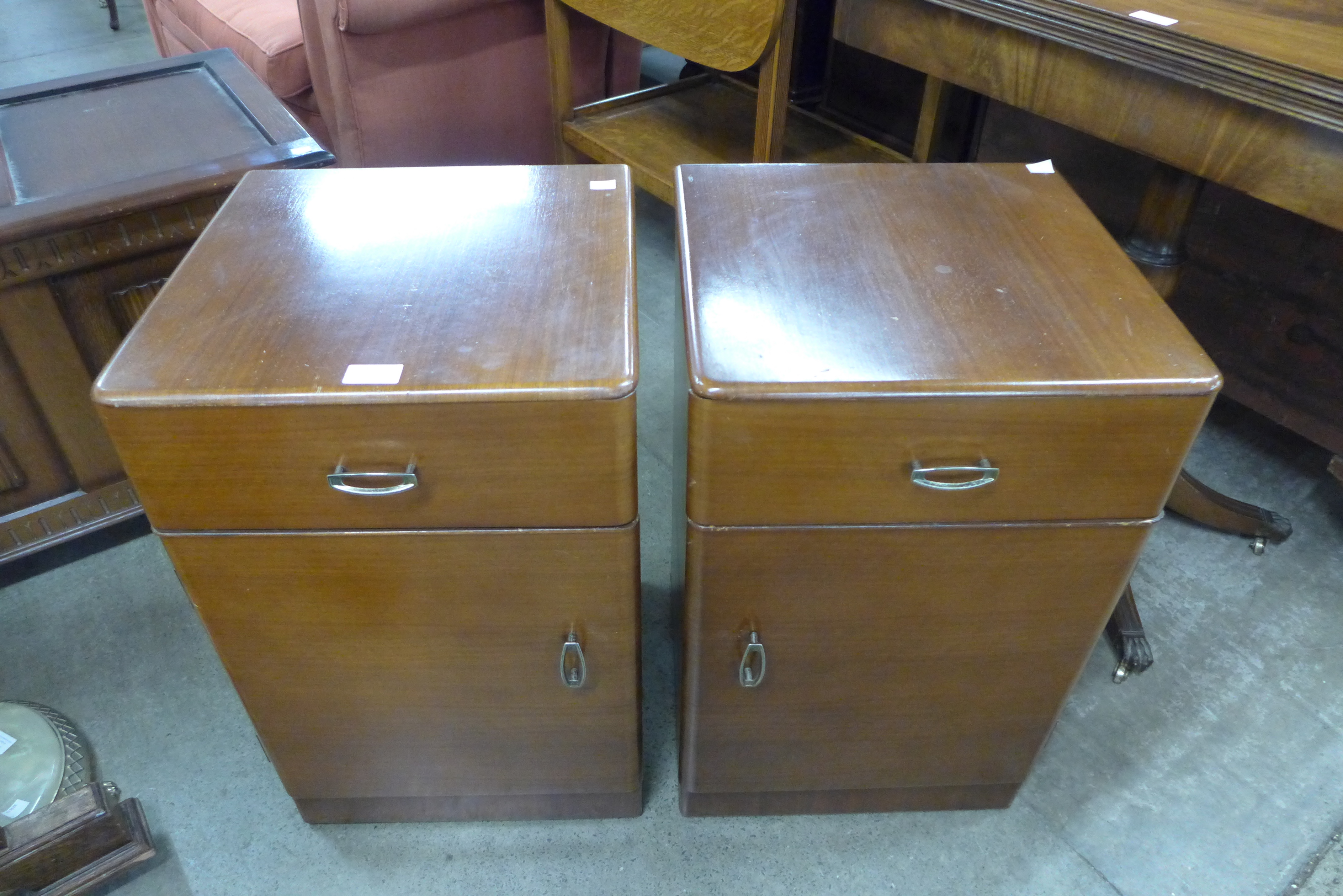 A pair of walnut bedside cupboards