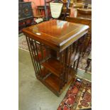 An Edward VII style inlaid mahogany revolving bookcase