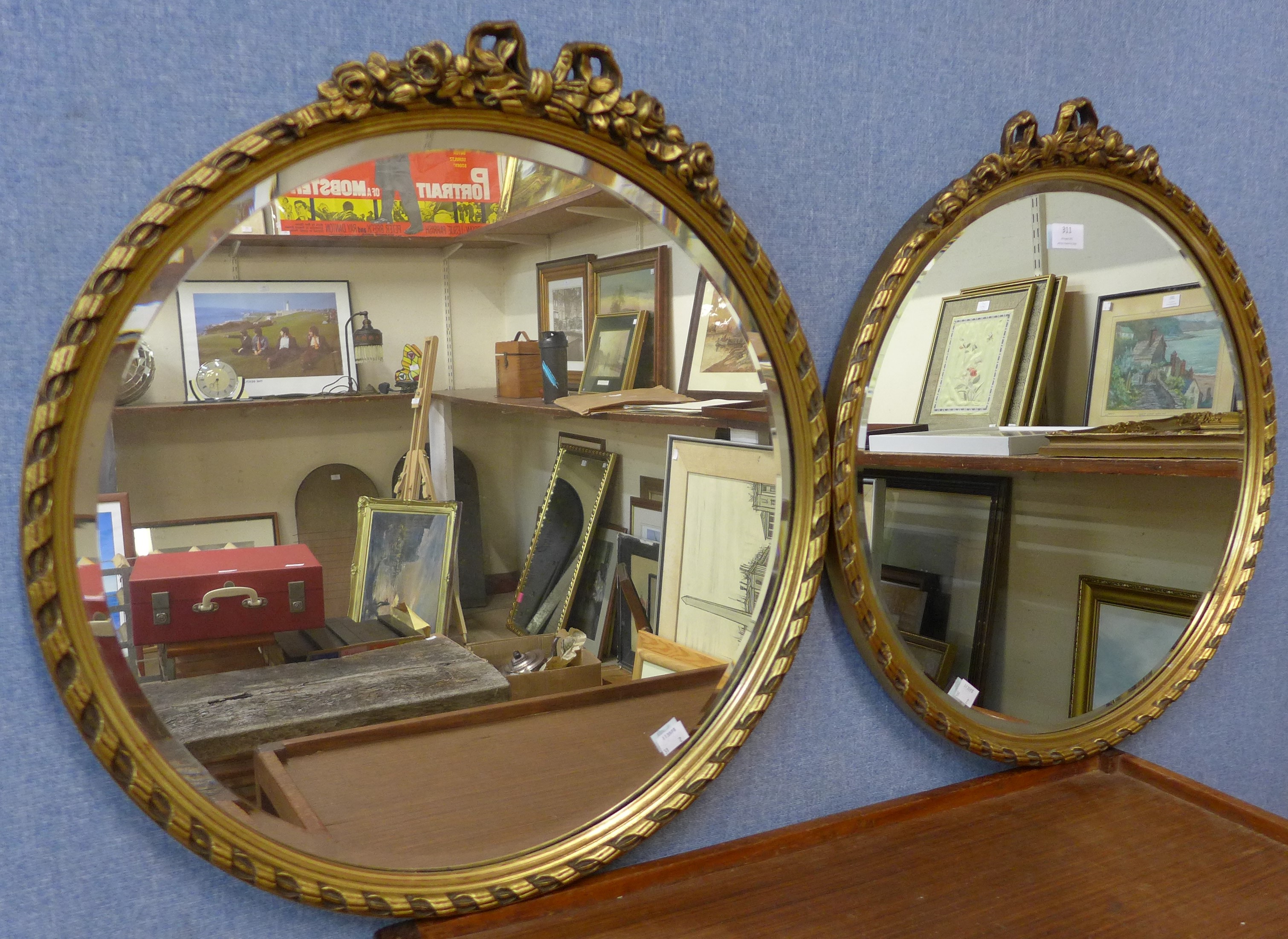 A pair of regency style circular gilt framed mirrors