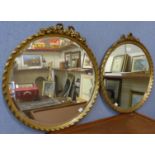 A pair of regency style circular gilt framed mirrors