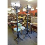 A pair of ebonised bentwood coatstands