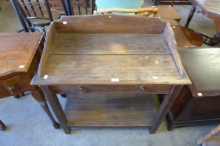 An early 20th century stained pine wash stand