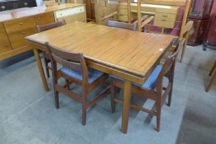 A White & Newton teak extending dining table and four chairs