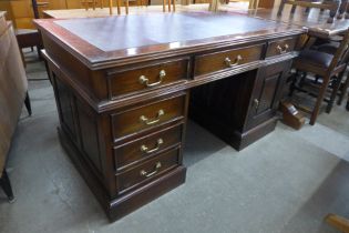 A mahogany and leather topped desk