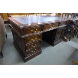 A mahogany and leather topped desk