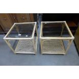 A pair of bamboo and glass topped occasional tables