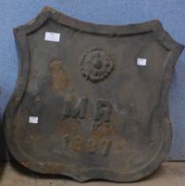 A cast iron armorial plaque, dated 1887