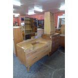 A G-Plan Brandon oak three piece bedroom suite, comprising chest of drawers, dressing table and a