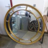 A circular gilt framed mirror