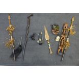 A collection of African items including spears, a carved wooden statue, etc.